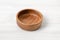 Wooden bowl. on white table.