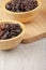 Wooden bowls of delicious dried raisins on a wooden table
