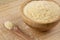 Wooden bowls of Grated Parmesan Cheese on a wooden background