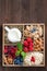 Wooden box with breakfast items - oatmeal, granola, nuts, berry