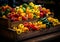 A wooden box filled with lots of different colored peppers. Vibrant assortment of peppers in a wooden box