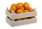 A wooden box with fresh mandarines isolated on the white background.