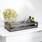 Wooden box with handles filled with small medicine bottles sits on a white mantelpiece. One of them contains a dried hydrangea