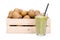 Wooden box with ripe kiwi fruits and a glass with fresh kiwi smoothie with a drinking straw