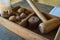 A wooden box with traditional wooden hammer to crack walnuts for