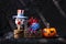 Wooden bozo ghost with color yarn spider in treasure box and halloween pumpkin