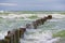 Wooden breakwater in the stormy sea. Seascape, Baltic sea near K