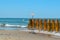 Wooden breakwaters on the seashore. Inscription in Russian: Located on the breakwater prohibited