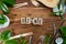 The wooden brick with words ` OZONE ` on wooden background. ECO concept with recycling symbol and leaves