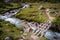 Wooden bridge across running river in the countryside