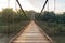 Wooden Bridge along the river to green forest