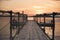 Wooden bridge on the beach and beautiful sunset near the sea