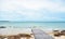 Wooden bridge on the beach and rocks,,cloudy and blue sky , summer background