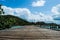 Wooden bridge and beautiful blue sky and white cloudy background on the sea beach at Khao Lam Ya, Rayong province.