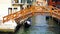 Wooden bridge, canal and gondola boat in old town