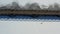 Wooden bridge construction on snowy frozen lake, aerial