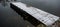 Wooden bridge is covered with white snow against the background