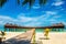 Wooden bridge leading to an exotic bungalow on the background of azure water, maldives