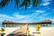 Wooden bridge leading to an exotic bungalow on the background of azure water, maldives