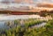 Wooden bridge on Narsjoen lake in Norway at sunset