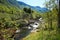 Wooden bridge over the river and beautiful scenery along the mountain hike to lake Myrdalsvatnet & Bondhus Lake, Rosendal, Norway.