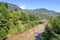 Wooden bridge over the river Talfer with mountain panorama in Bolzano, South Tyrol, Italy