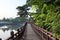 Wooden bridge over the Uirimji Reservoir leading to a gazebo overlooking the lake in Jechun, South Korea