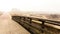 Wooden bridge and road. Autumnal misty morning on the coast of Texel island, the Netherlands