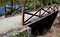 Wooden bridge with a stone foundation newly built for cyclists over a stream by the pond. wooden beams connected by screws and met