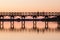 Wooden bridge at sunset with silhouettes of people. Quinta de Lago
