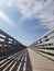 Wooden bridge under cloudy blue skies