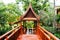 Wooden bridge, walkway, through Thai style pavilion,