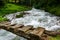 wooden brigdge over a rushing cold mountain creek while hiking