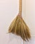 Wooden broom on a wall background