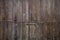 Wooden brown aged door, rusty latch and padlock. Close up, details