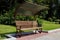 Wooden brown bench with canopy in city park