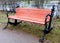 Wooden brown bench with iron anchors on the sides in the Park