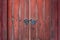 Wooden brown rural door with metallic rustic handles and a lock