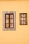 Wooden brown windows. Orange wall.