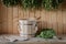 A wooden bucket and a birch broom in a Russian bath. Sauna.