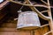 Wooden bucket for milking sheep and cows drying on the tree in front of the shepherd`s hut