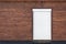 Wooden building facade. Brown wood siding wall with white shutter door. Copyspace