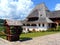 Wooden building and a well at Barsana orthodox monastery, Maramures