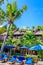 Wooden bungalows and blue sunloungers with umbrellas, Nusa Lembongan, Indonesia