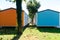 Wooden bungalows inside a summer campsite with brightly painted boards