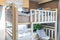 A wooden bunk bed with a pillow and air conditioner in a childre