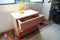 wooden bureau on top of a rug, side table, night table