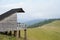 A wooden cabin with a panoramic view of the mountains and the forest. A place for tourists to rest, the home of a forester or