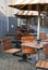 Wooden cafe chairs, tables and umbrellas