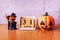 Wooden calendar block disrupted show date 31 october halloween day and toy pumpkin on wooden background. Halloween concept